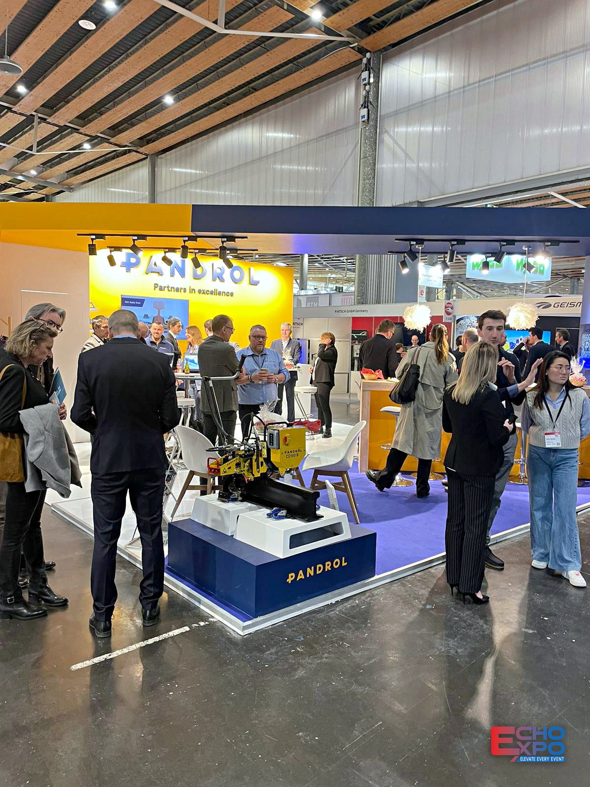 Visitors around a rail track product display on the PANDROL stand at SIFER Lille during show hours.