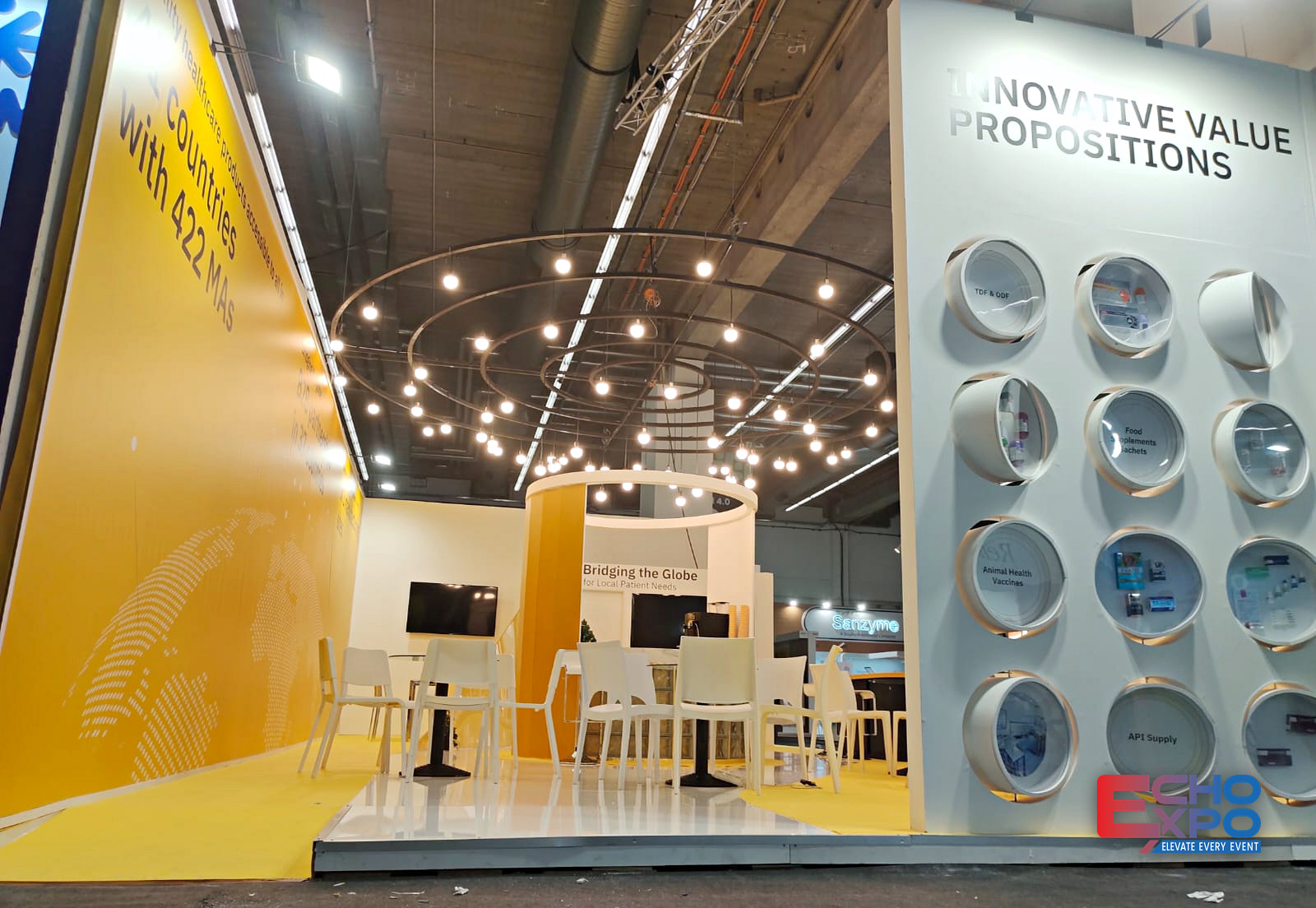 EVA Pharma 78 m² exhibition stand at CPHI Frankfurt 2022, with a yellow angled brand wall, suspended circular light rings and a product display wall of recessed circular vitrines.