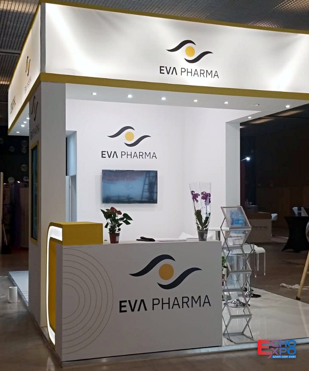 EVA Pharma 28 m² exhibition stand at ESCEO Barcelona 2023, with an illuminated white fascia, a curved reception counter and a wall-mounted screen.
