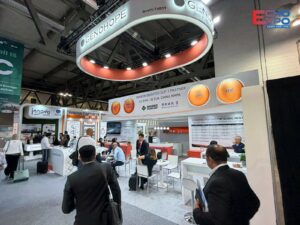 Finished Genohope stand at CPHI Milan 2026 under its suspended ring, with visitors in the meeting area in Hall 16.